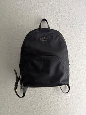 kate spade black nylon backpack with front zip pocket and logo